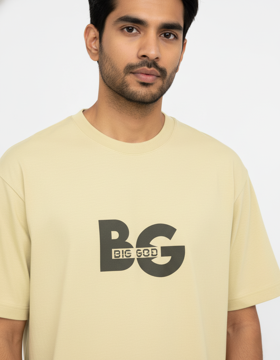 Man wearing a beige t-shirt with 'BIG GOD' logo