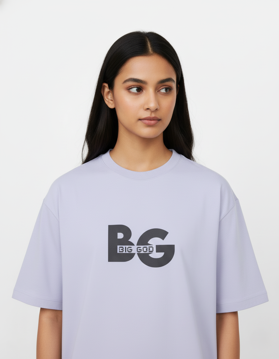 Person wearing a light Lavender t-shirt with 'BIG GOD' printed