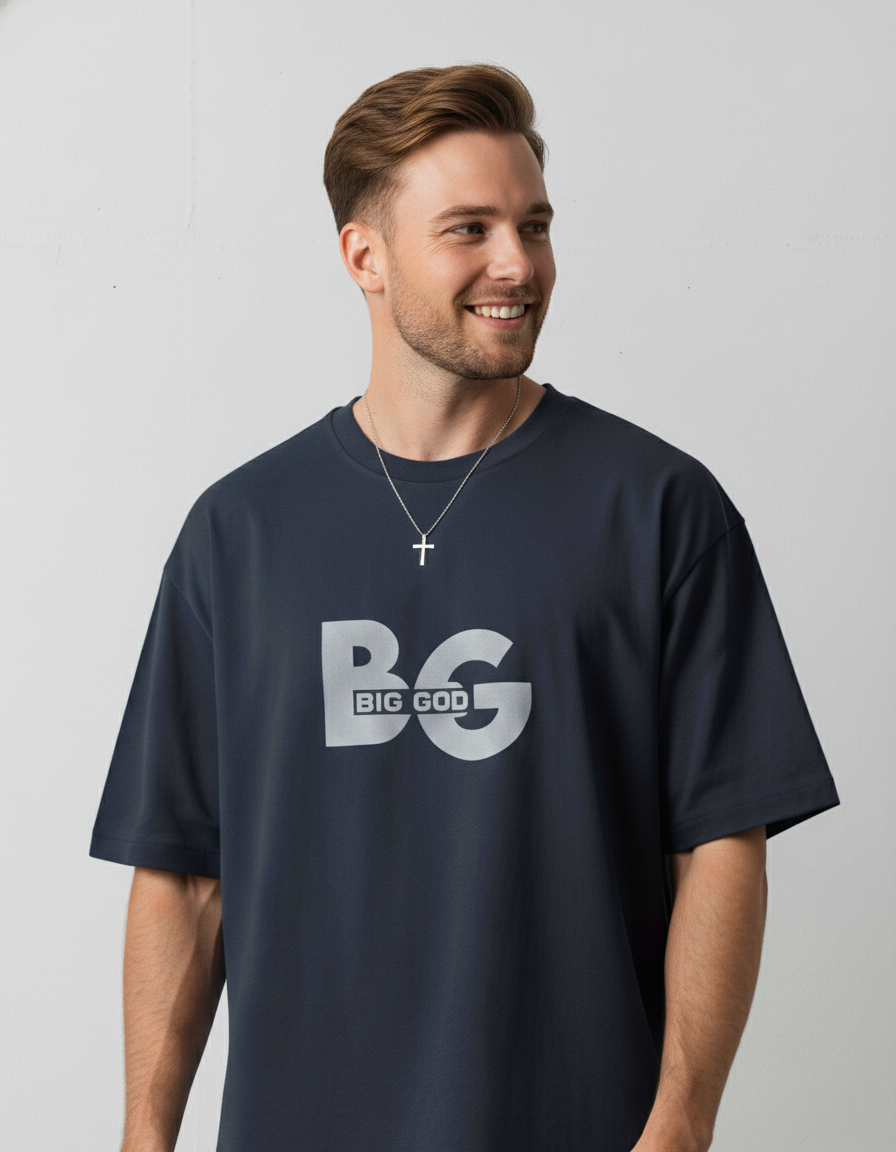 Man wearing a navy blue t-shirt with 'BIG GOD' printed on it against a plain background